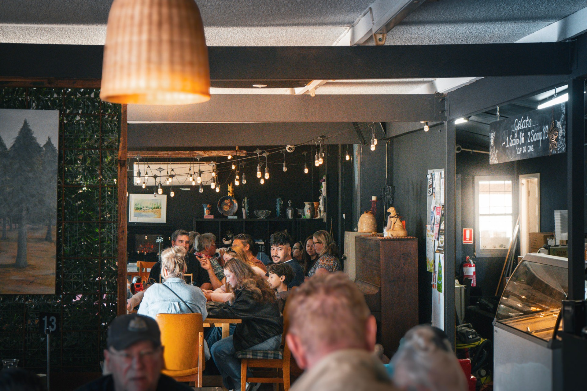 A long table of friends and family gathered inside The Hive